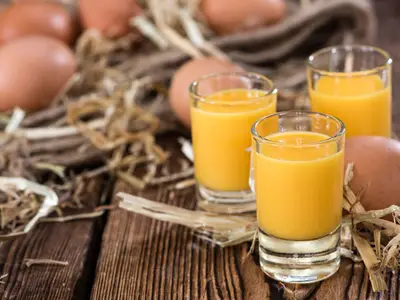Egg Liqueur (close-up shot) on wooden background