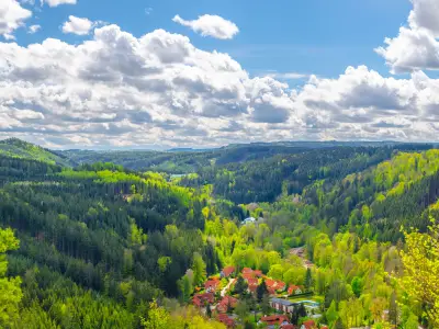 Slavkov Forest aerial panoramic view with small village, mountains, green hills and trees near Karlsbad town. Panorama of Karlovy Vary district, West Bohemia, Czech Republic