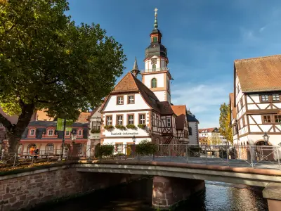 Erbach, Germany - OCTOBER 17, 2022: The town-hall and the river Mumling in Erbach with half-timbered houses on a sunny day.